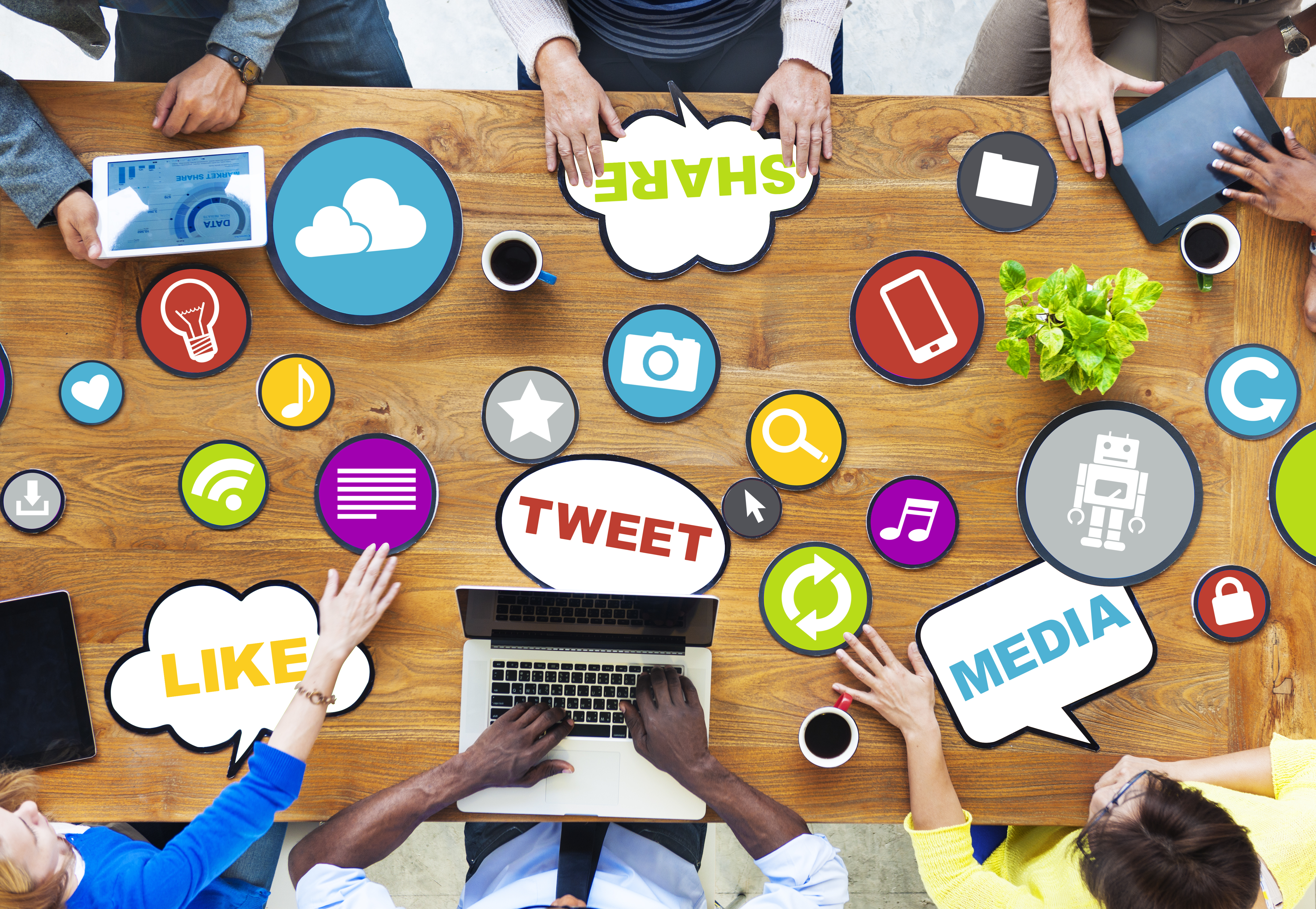 people at desk with word bubbles